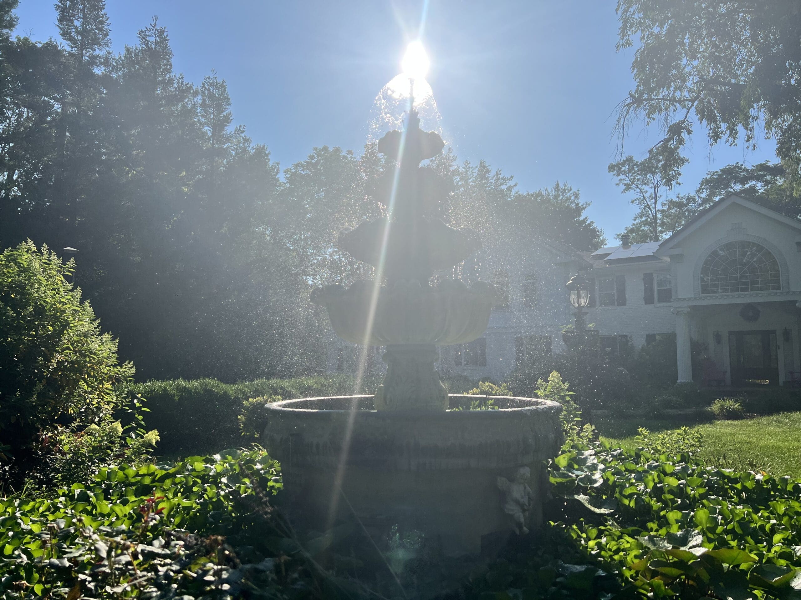 Sun setting over large fountain